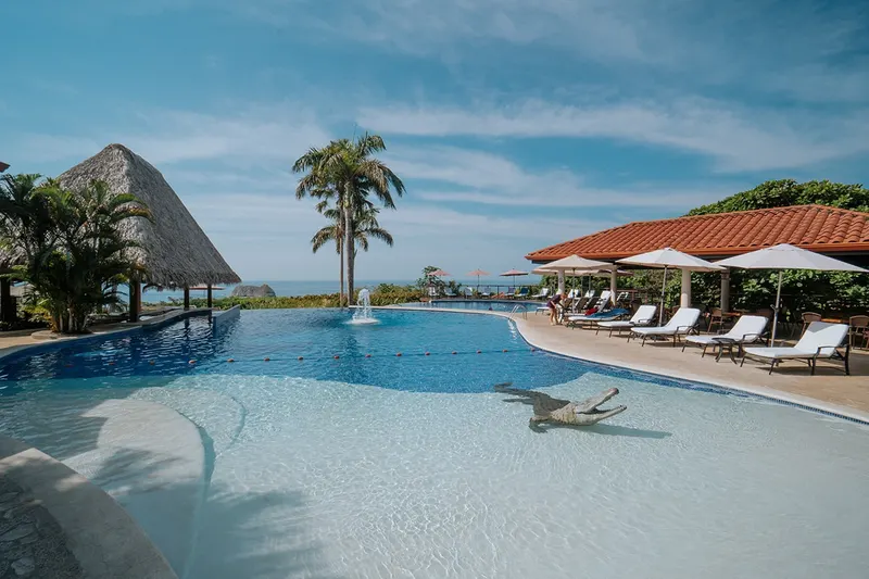 Pool loungers and umbrellas at Parador