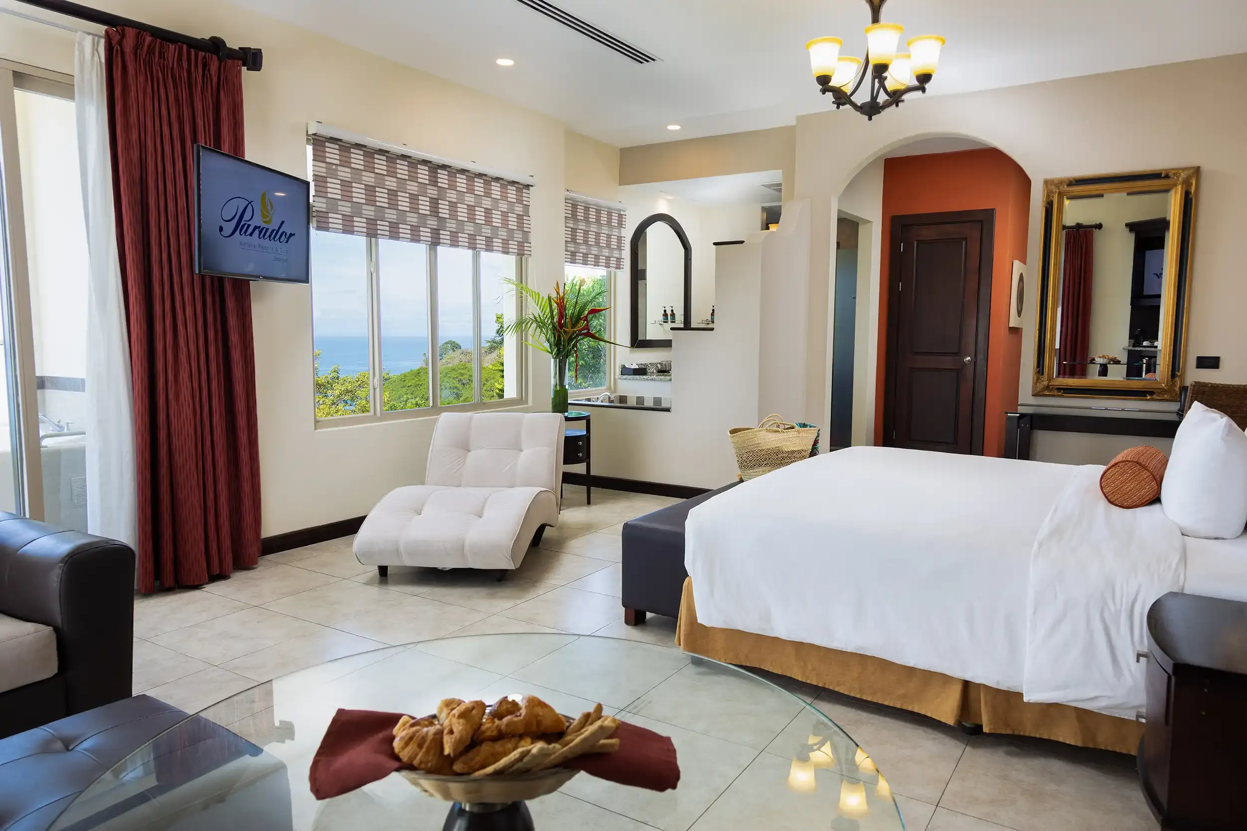 Vista Pacifico room with king bed, chaise lounge and an ocean view window